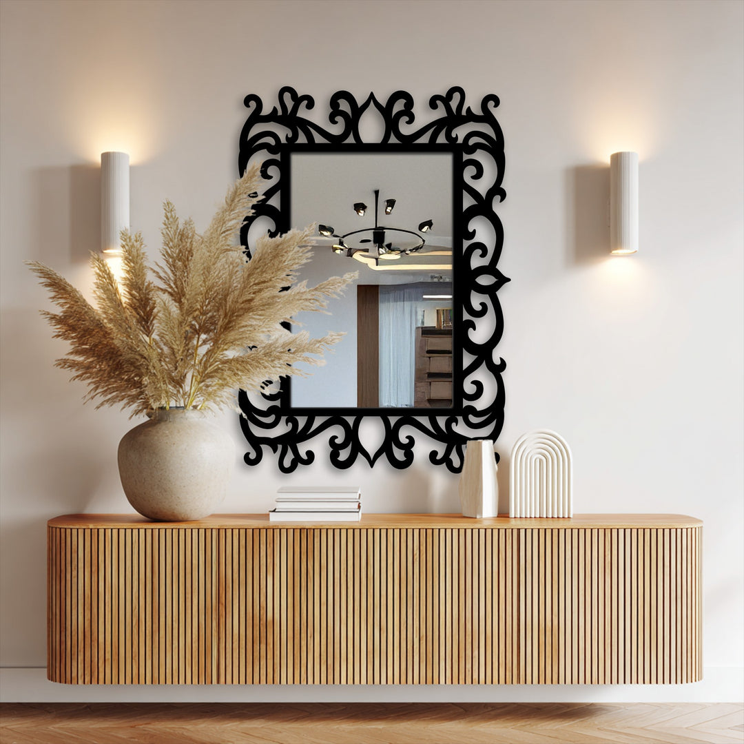 Neutral wall backdrop emphasizes a black ornate floral metal frame, enhancing its reflections as it acts as a centerpiece for the modern wall mirrors.