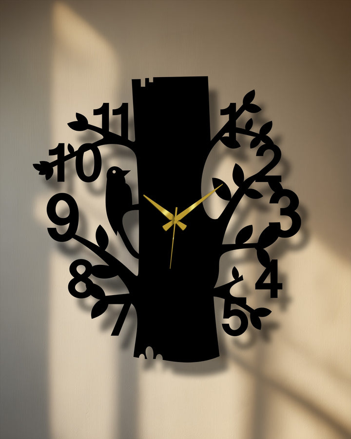 Illuminated by a shaft of light, this nature tree design metal art for wall clock features a forest bird silhouette and elegant gold hands against a light background.