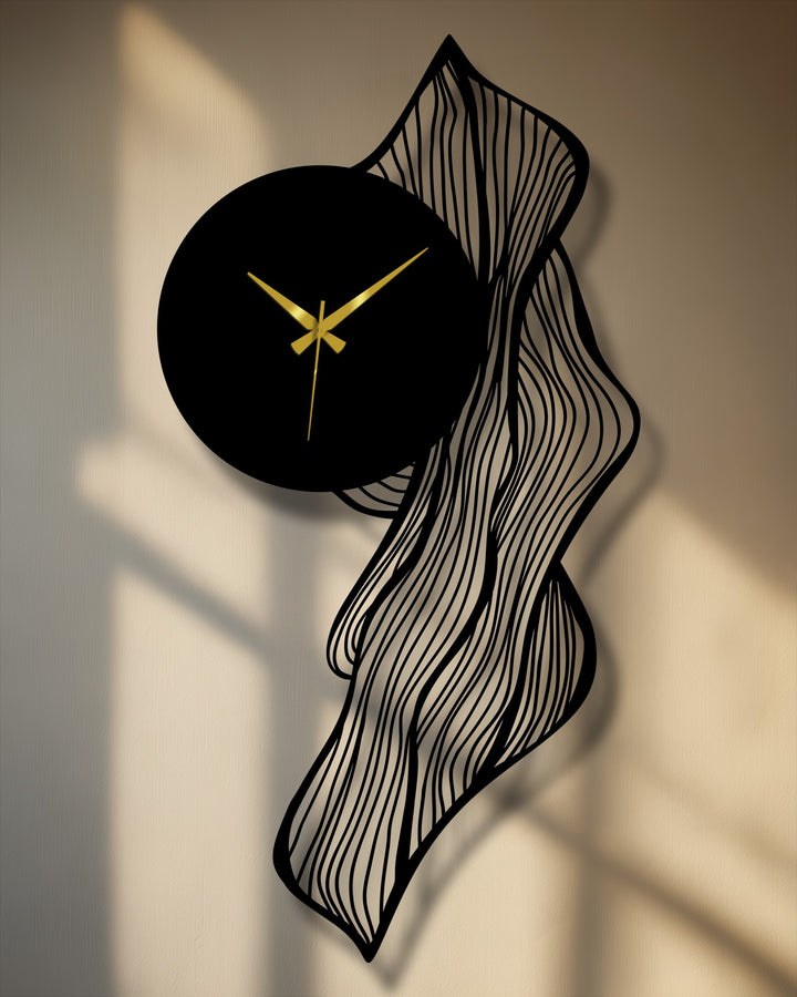 Defined by its elegant edge and borders, this flowing abstract leaf metal wall clock creates an interesting line as a piece of metal art for wall decor.