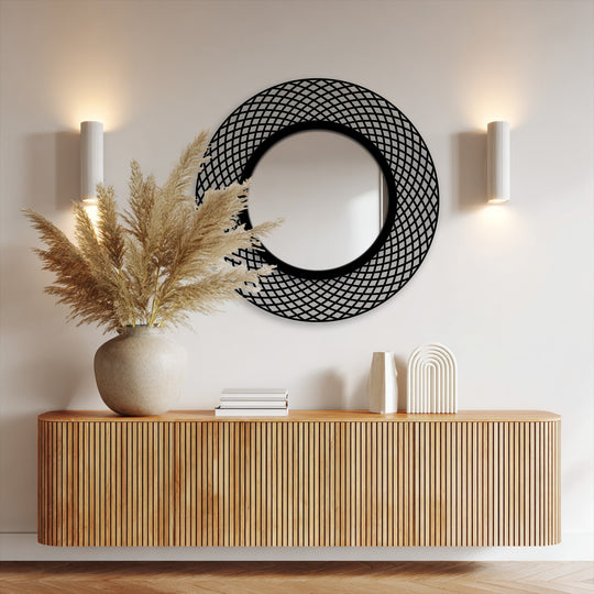 Reflecting light, the modern mirror showcases a smooth transition between interior and exterior frame, highlighting the interwoven geometric design.