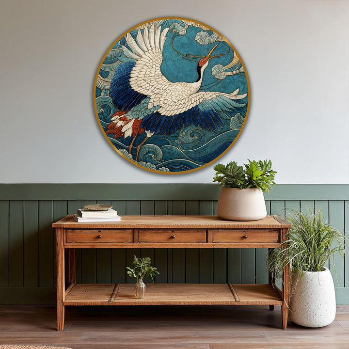 Aged wall paneling in shades of olive and soft gray highlights the vibrant oil painting artwork of a crane in flight against an artistic turquoise sky.
