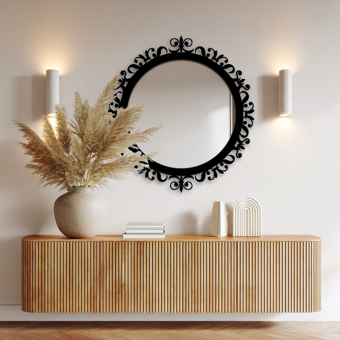 Organic forms like feathery pampas grass beautifully complement the ornate scrolling patterns of this modern mirror's black frame.