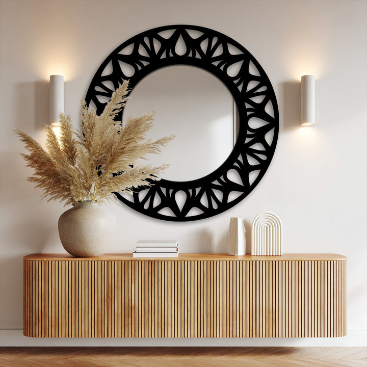 High color contrast is showcased between the black, floral cutout frame and the clear glass in this modern stained glass wall mirror design.