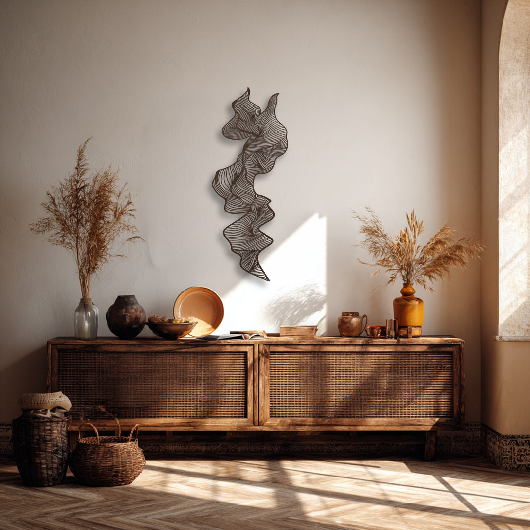 Striking contrast between the deep brown vertical abstract metal wall decor and the bright, textured beige wall above warm neutral furnishings.