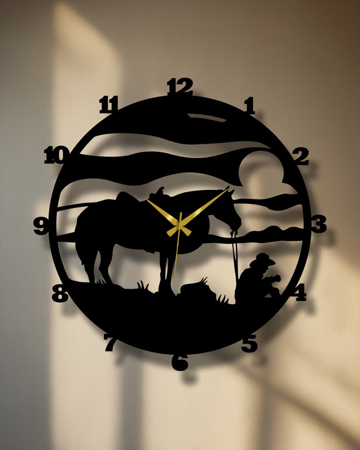 The sweeping lines of this decorative metal art clock capture the quiet moment of a cowboy and horse as they pause, conveying a sense of tranquility.