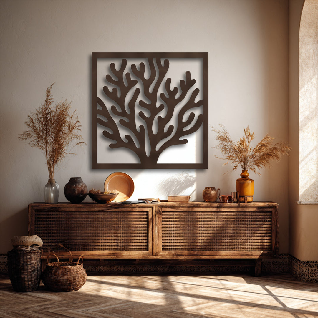 The striking color contrast of the deep brown coral frame metal artwork against the light wall accentuates its intricate ocean-inspired design.