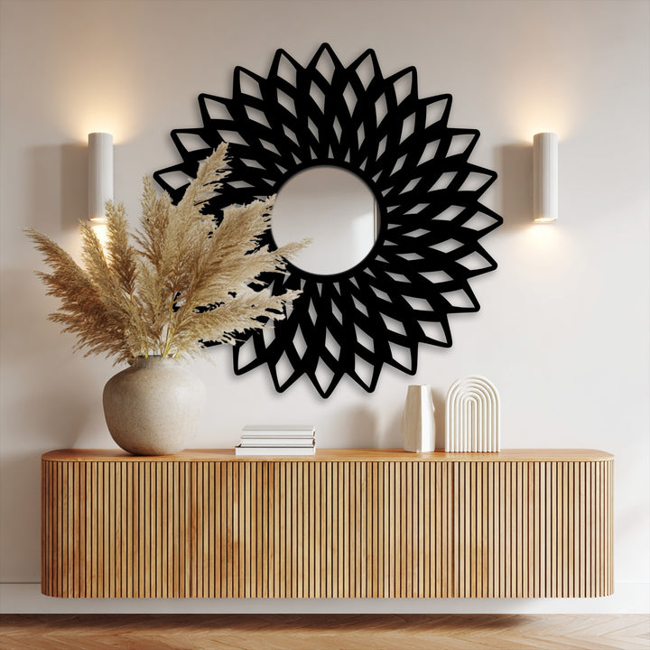 The realistic detail highlights the intricate black metal artwork mirror frame, featuring pampas grass and the ribbed wooden console.