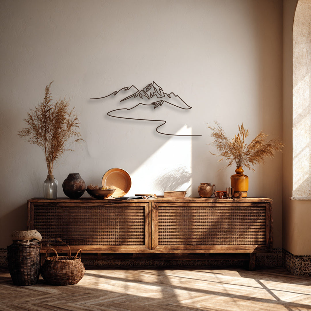 Strong sunlight illuminates a minimalist mountain metal wall decor, casting intricate shadows on the textured wall and chevron floor.