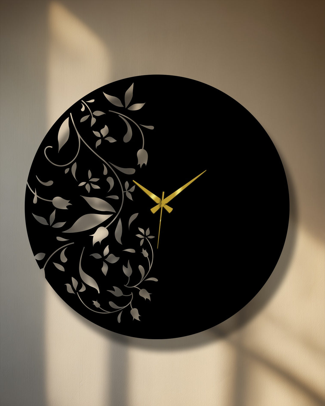 Negative space highlights the elegant floral design of this black metal wall clock, a piece of captivating metal art for wall with golden clock hands.