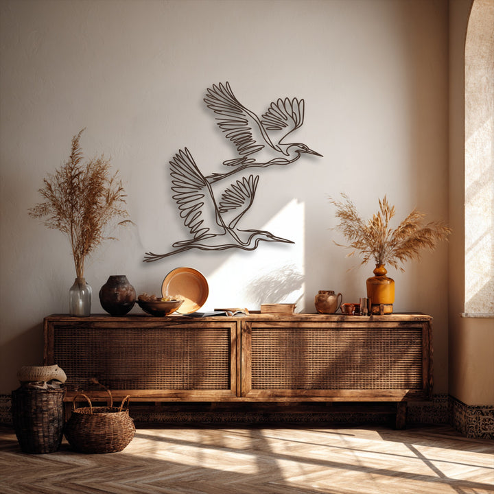 Creating profound depth and visual layers, the minimalist metal art for wall with graceful flying herons contrasts beautifully against a textured wall.