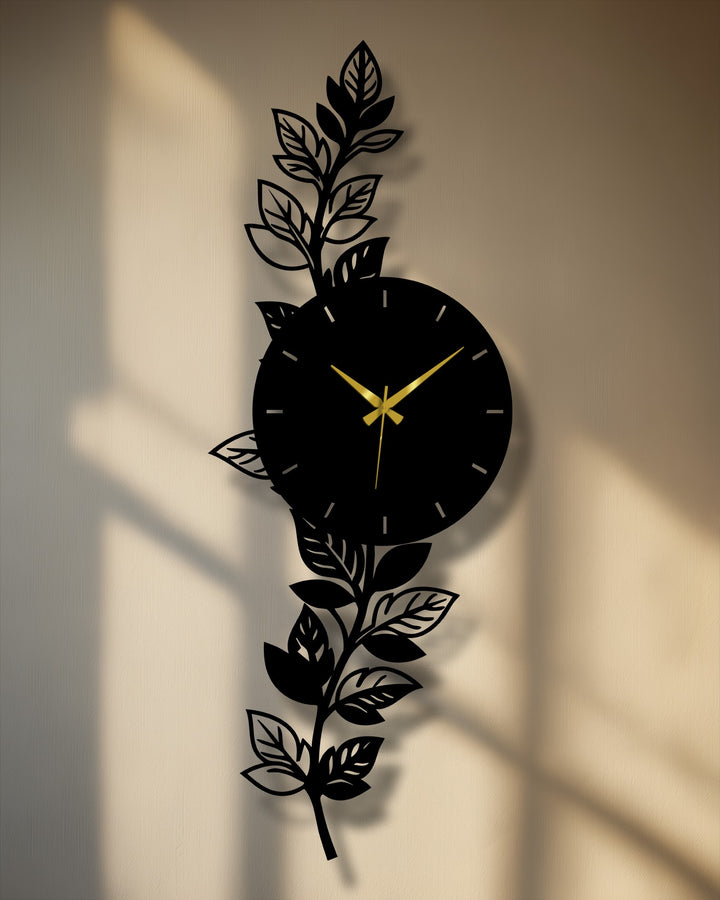 Botanical leaf metal artwork presents a modern wall clock featuring an intricate, nature-inspired design with golden hands, serving as the central subject.