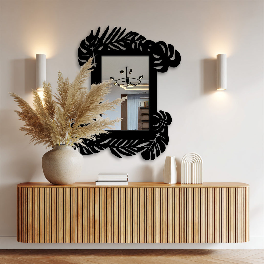 Reflecting the room's light, this tropical leaf frame metal wall mirror reveals a gradient where its botanical black frame meets the glass, a stylish example of unique metal wall art.