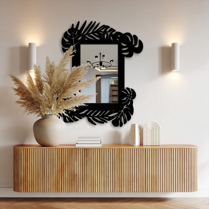 Reflecting the room's light, this tropical leaf frame metal wall mirror reveals a gradient where its botanical black frame meets the glass, a stylish example of unique metal wall art.