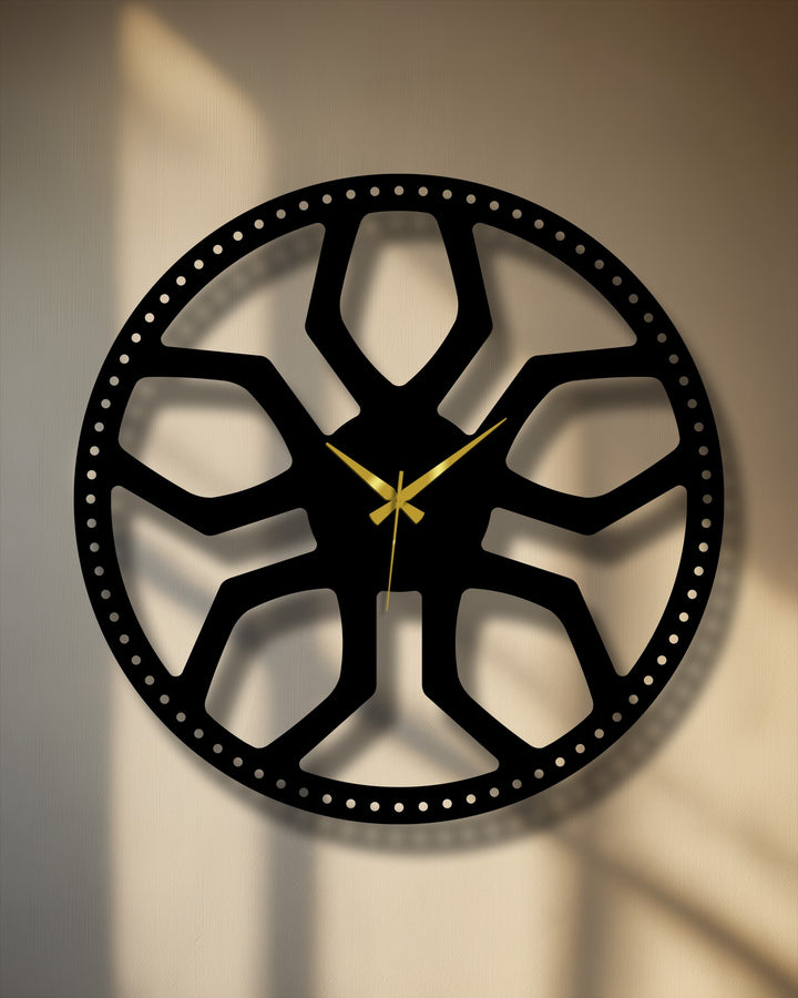 A distinct color transition from soft beige to warm brown illuminates the wall behind a unique metal wall art clock with an abstract radial pattern.
