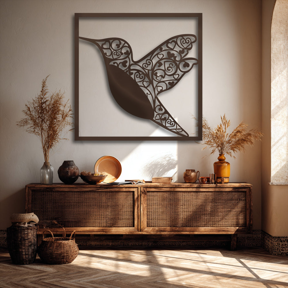 Soft dried grasses on a rustic cabinet are bathed in sunlight beside elegant Hummingbird Heart Metal Wall Art, enhancing the metal wall decor.