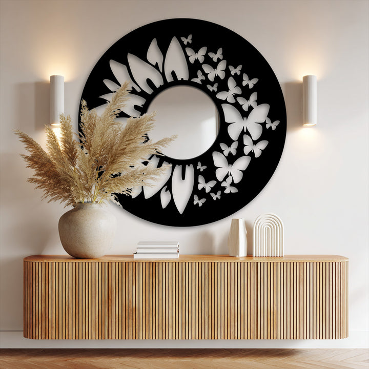 Subtle shadows accentuate the black metal frame and delicate butterfly cutouts surrounding the Butterfly Bloom bathroom mirror, highlighted by adjacent sconce lighting.