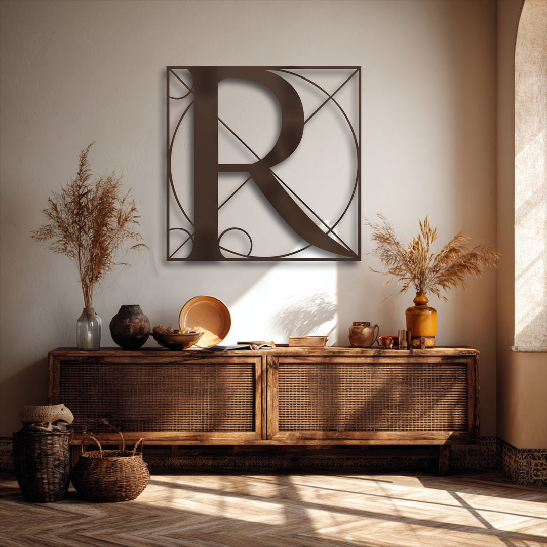 Woven baskets rest on a sun-dappled herringbone wooden floor, complementing the Geometric Letter R metal art for wall hanging above.