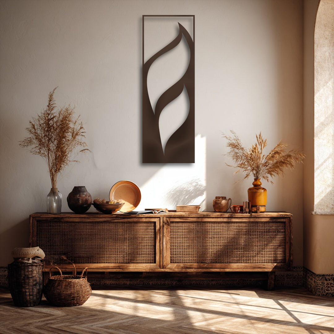 The striking negative space within the flowing leaves minimalist vertical metal decoration wall art beautifully contrasts with the light wall.