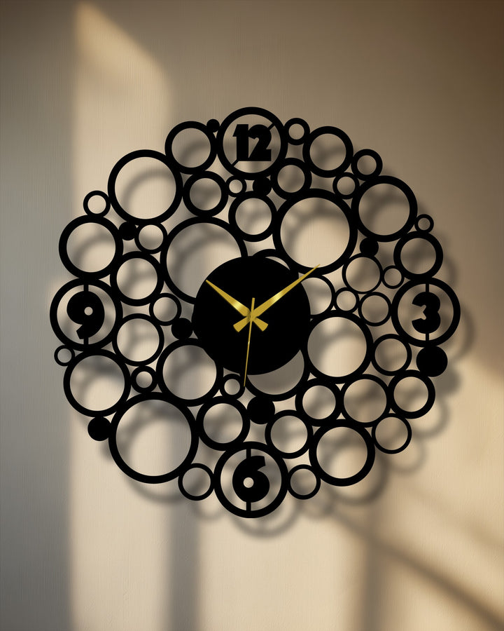 The darkest area highlights the laser-cut details of this metal circle wall clock, a modern decoration wall art piece with gold hands.
