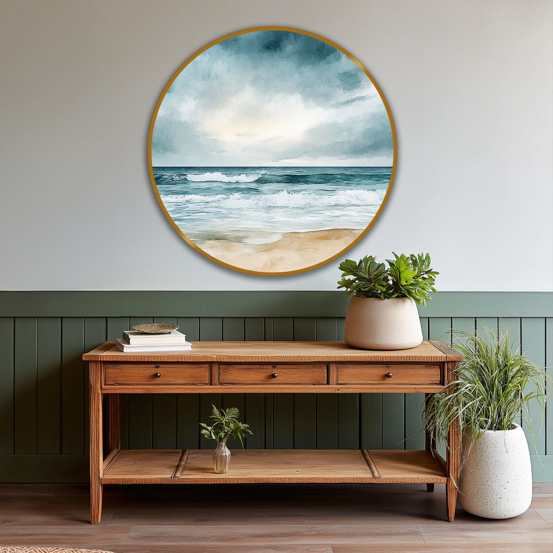 Subtle light and shadow enhance the depth in this round, coastal scene showcasing a beach horizon in a serene oil painting art piece, framed in gold.