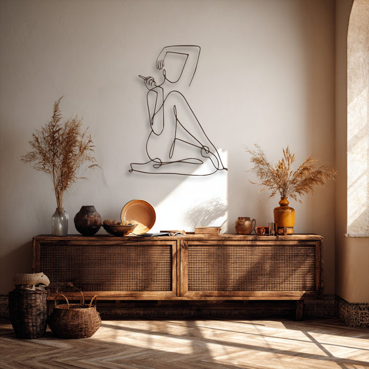 The flowing lines of the elegant female line art metal artwork create a dynamic sense of calm motion and grace on the wall.