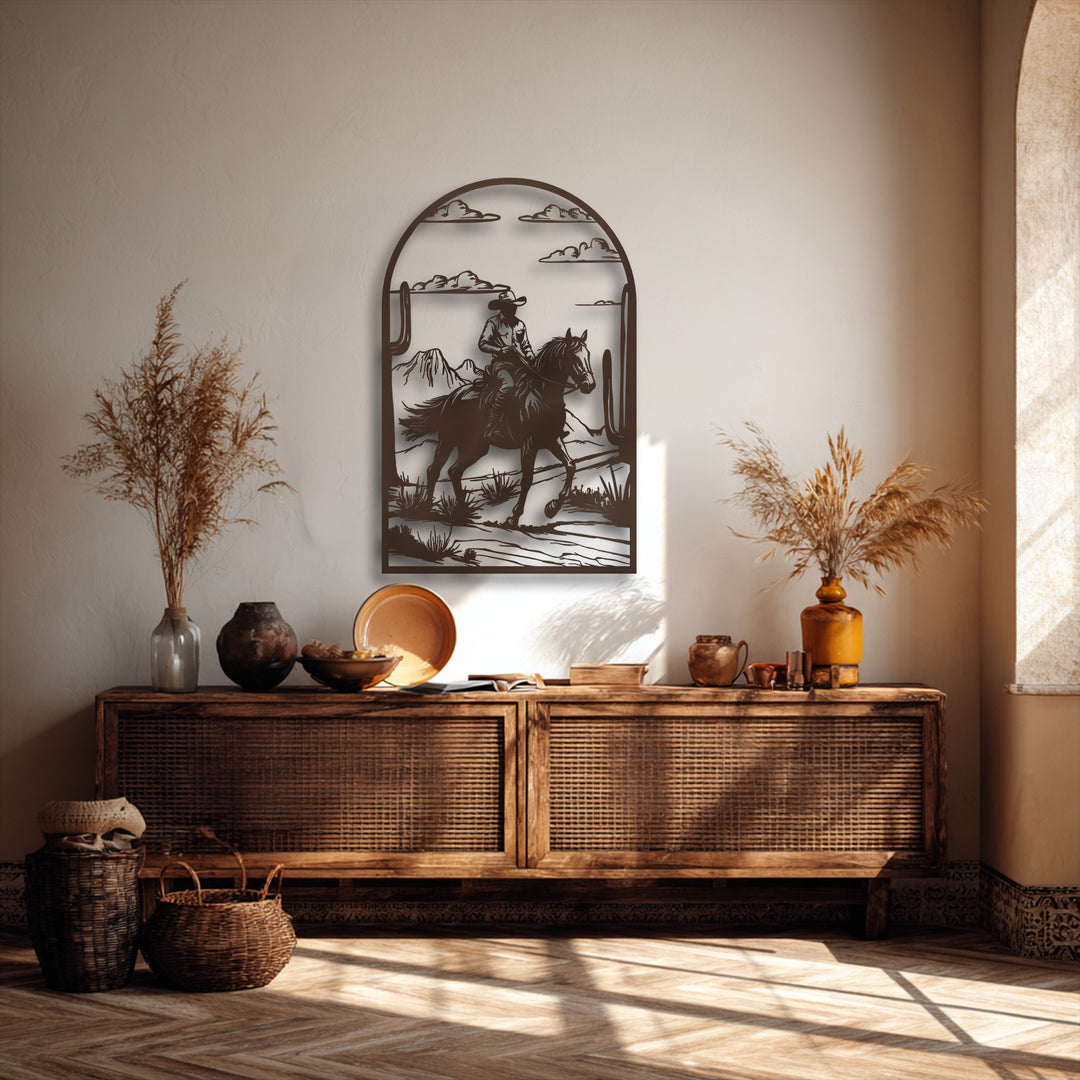 The layered design of the desert cowboy ride metal artwork exhibits a striking depth between the foreground rider and distant mountains.