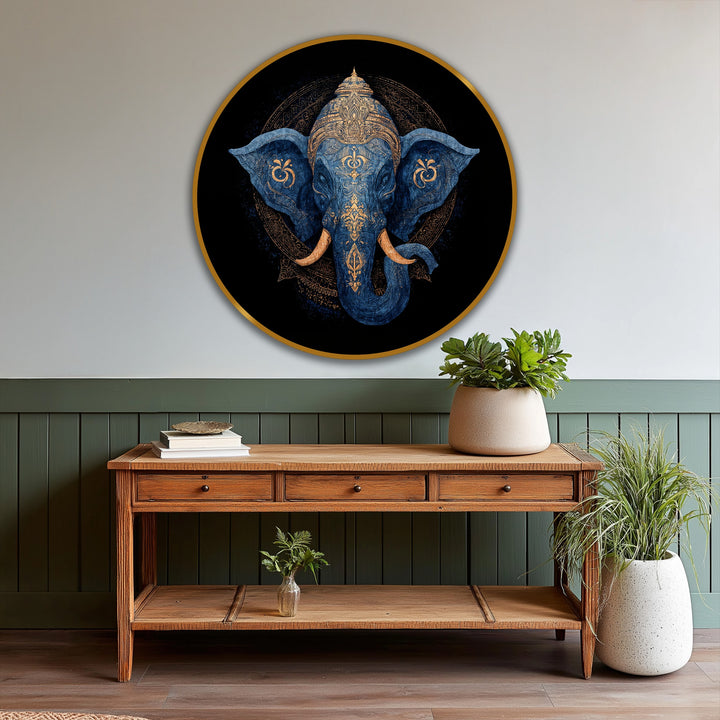 Foregrounded potted plants and a rustic wood console table showcase a 'Divine Indigo Majesty' sacred elephant round oil painting art prints displayed above.