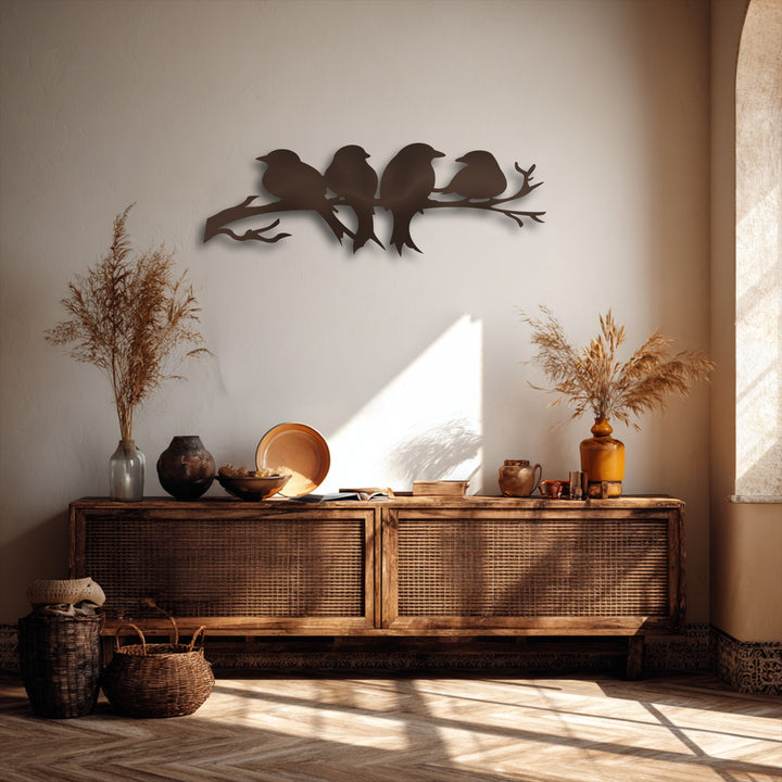 The prominent dark silhouette of four birds on a branch metal artwork captivates as the room's central focal point.