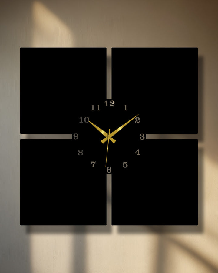 Four distinct black square panels form a striking geometric arrangement for this modern metal decoration wall art clock with golden hands.