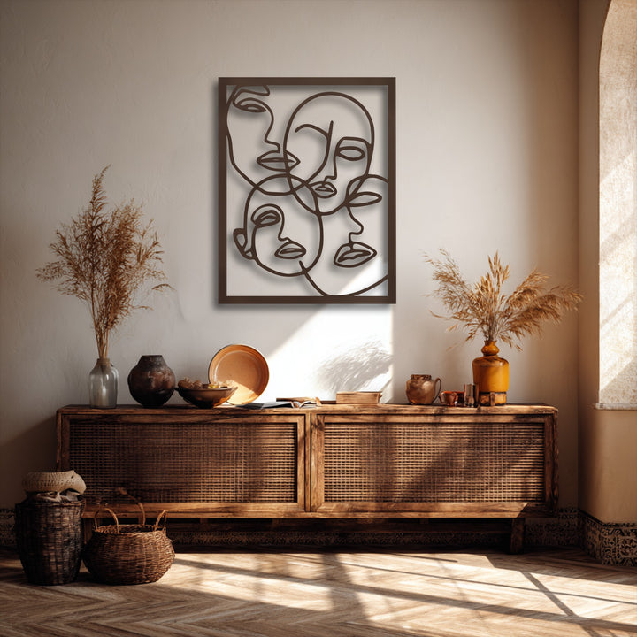 The realistic detail of the abstract faces line art metal wall decor creates captivating shadows on the textured wall.