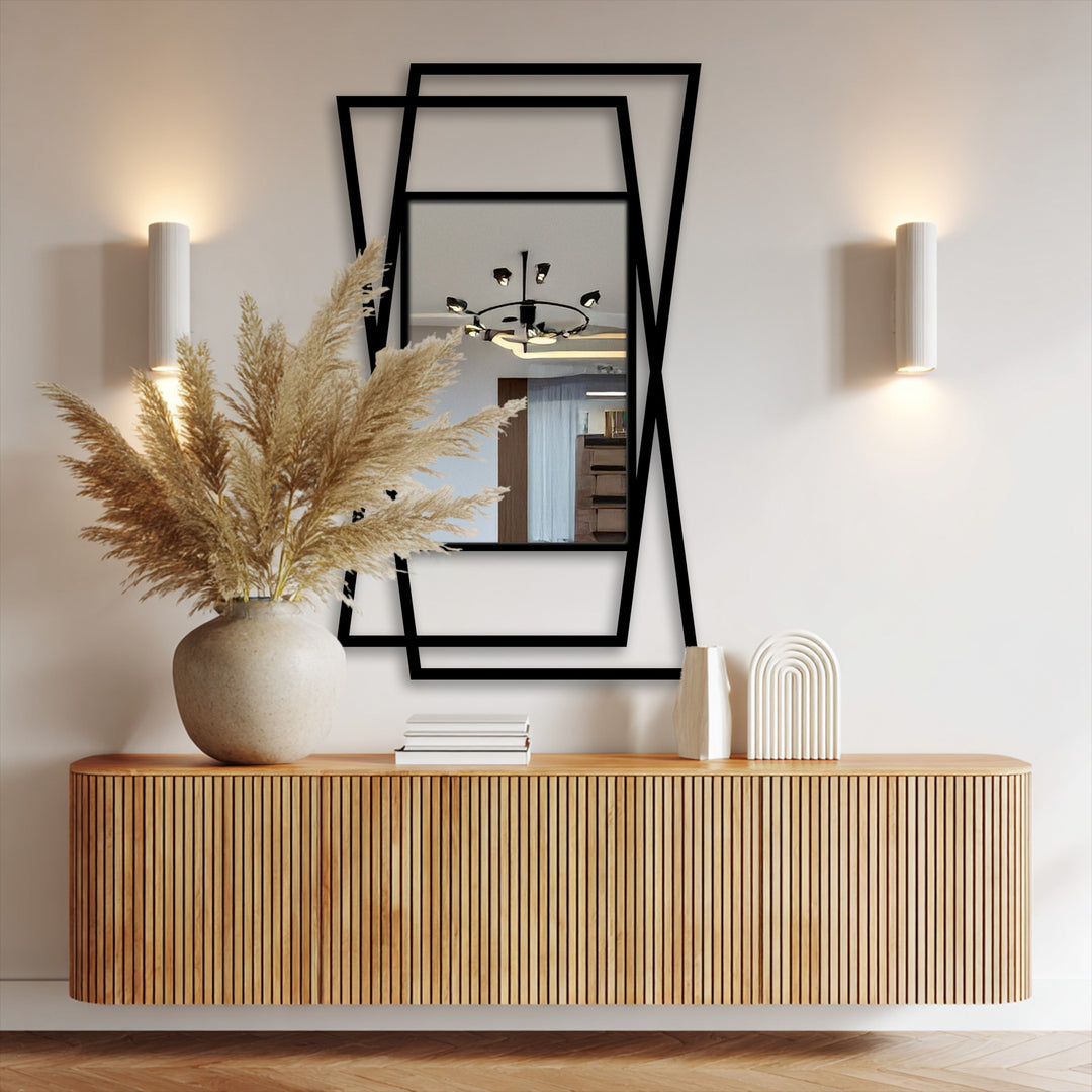 The geometric elements of this minimal mirror feature a sleek, black metal, layered frame creating depth, perfect as a modern framed wall mirror.