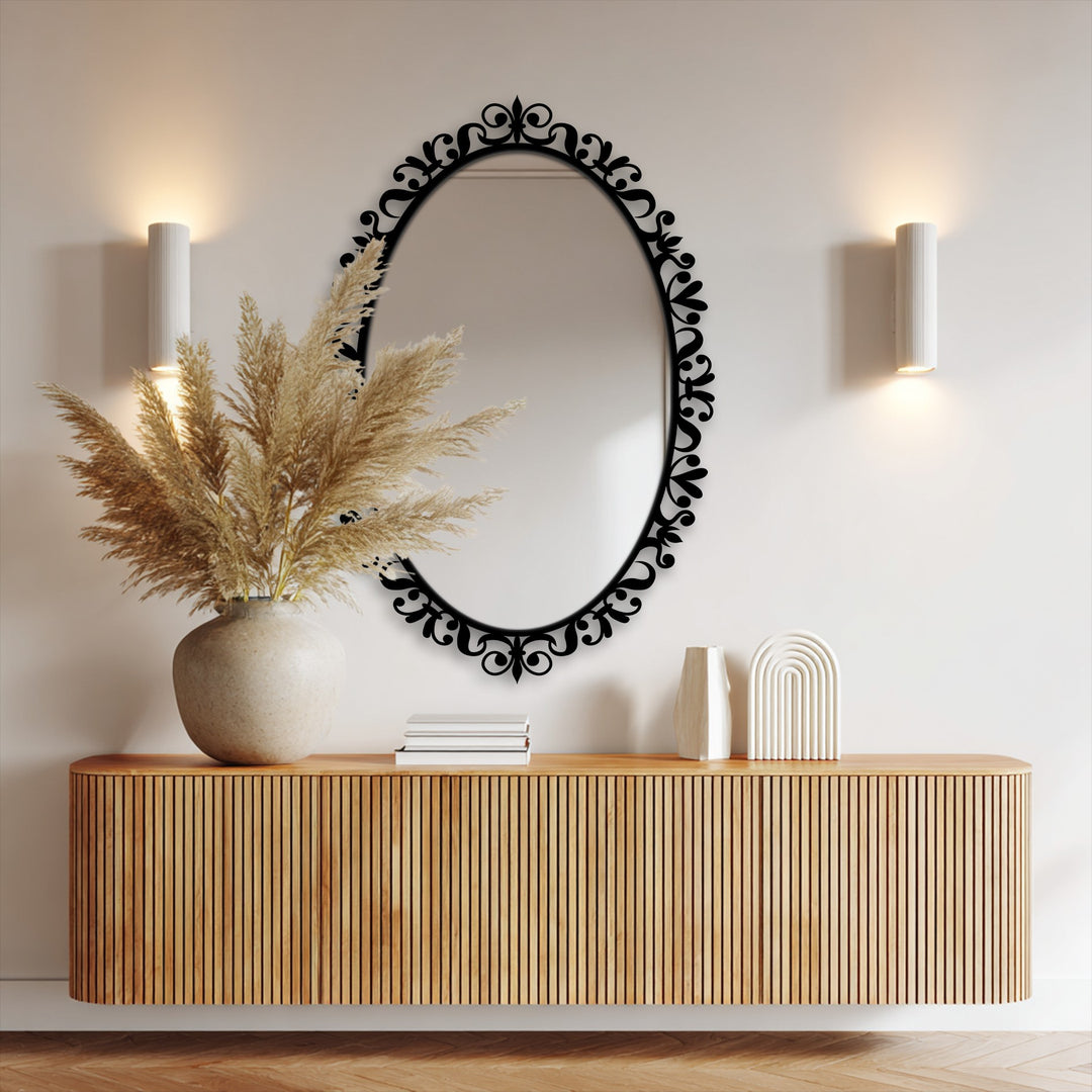 Vertical oval bathroom mirror features an ornate floral scrollwork black metal frame, providing a decorative and reflective focal point.