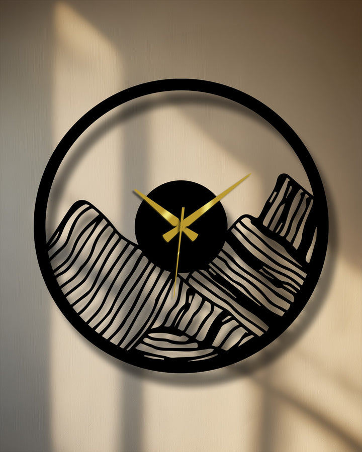 Softly illuminated backdrop highlights the design of this unique metal wall art clock featuring a canyon landscape cut-out, contrasting with the hard lines of the frame.