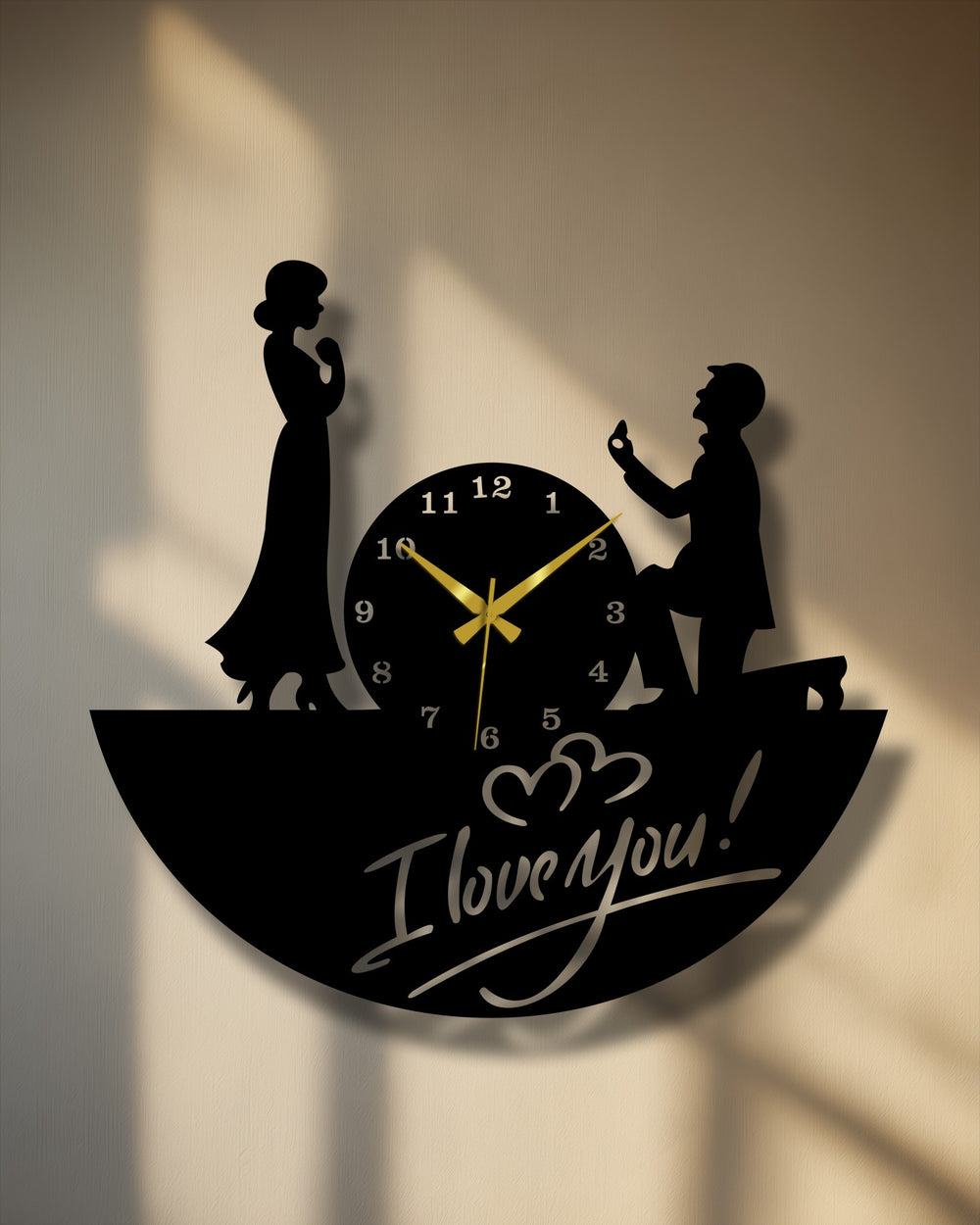 Showcasing its quality through intricate silhouette design and a smooth finish, the decorative metal art love proposal clock features elegant gold hands.
