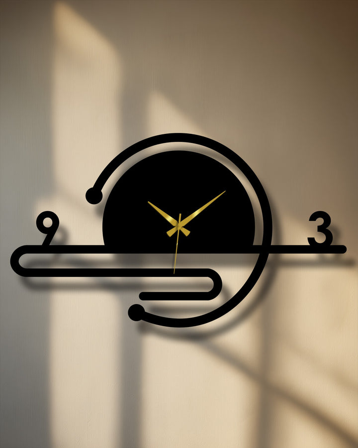 With its warm-toned lighting, the minimalist orbit line metal wall clock makes an inviting decorative wall art piece with geometric lines and gold hands.