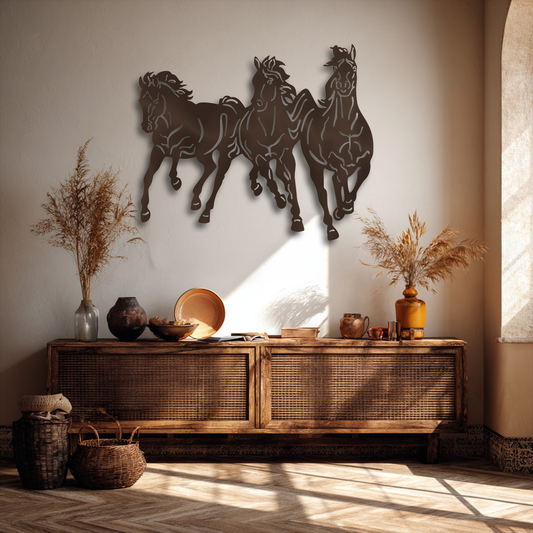 The decorative metal art of galloping horses creates compelling depth and layers against the wall, complementing the layered objects on the cabinet below.