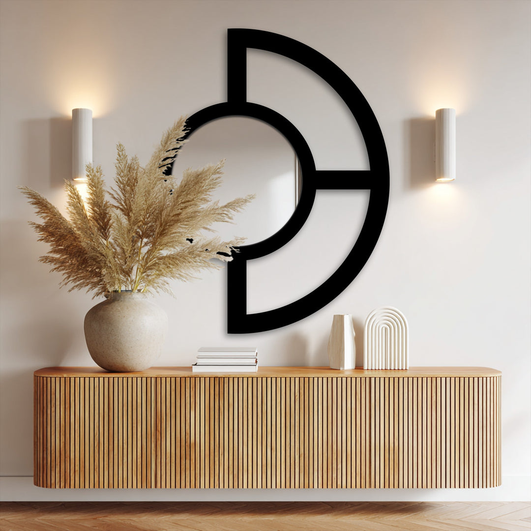 Soft pampas grass plumes stand as the softest element near an abstract half circle metal wall mirror, a balance design offering unique metal wall art.