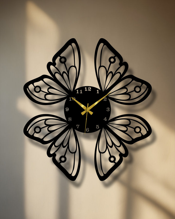 The stillness of the shadows accentuates this elegant butterfly wings metal wall decor clock, marking time on a textured wall.