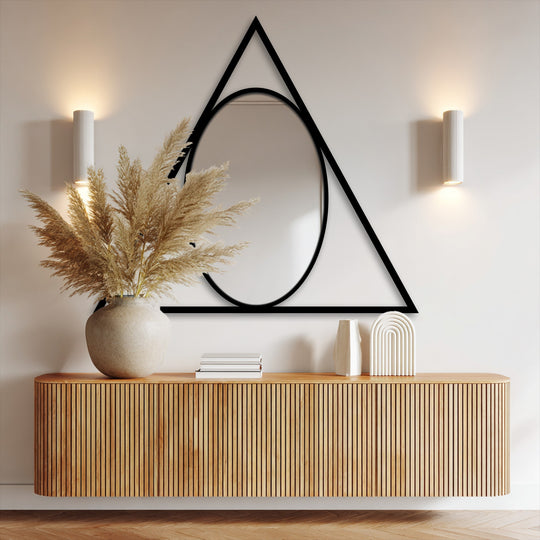 Foreground features the modern mirror reflecting ambient light above a natural wood cabinet.