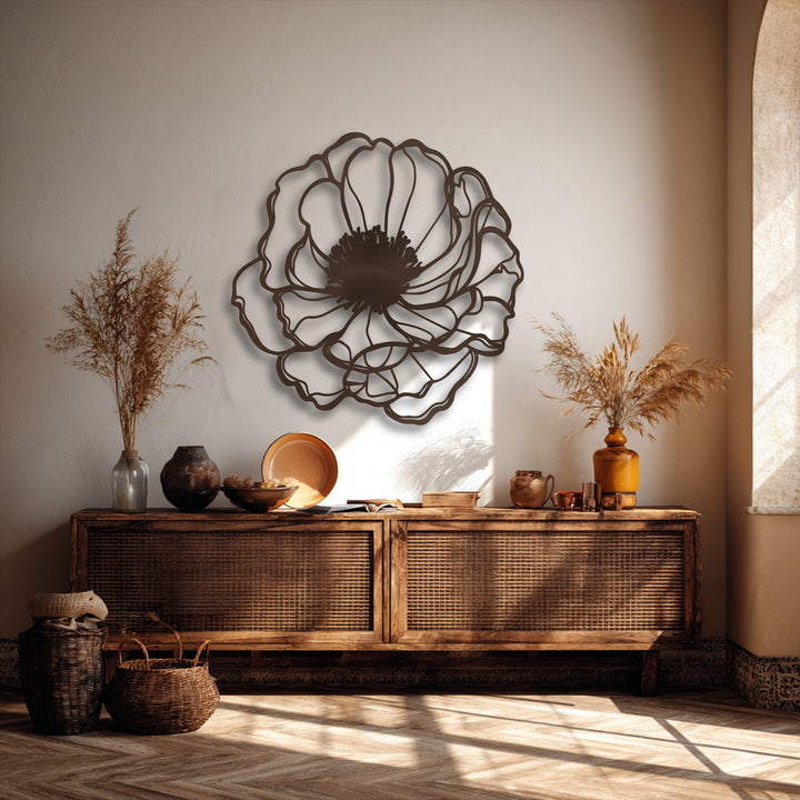 The central subject, an elegant bloom outline, is a minimalist floral metal art for wall with intricate dark brown petals on a light wall.