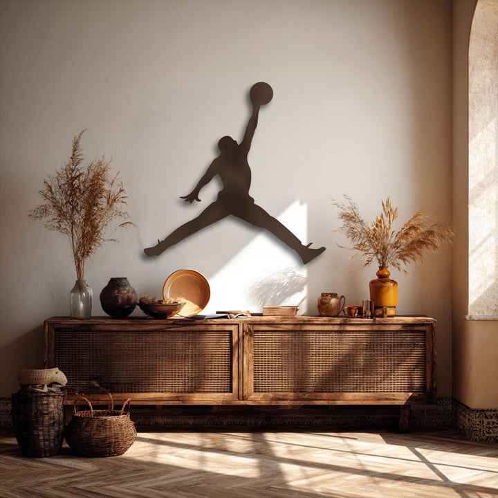 The stark color contrast dramatically presents the dark basketball jump player metal art for wall against the sunlit, textured wall.