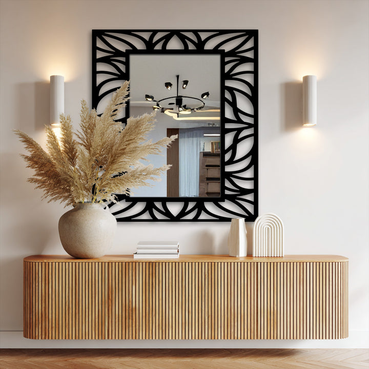 Negative space defines the flowing organic leaf pattern in this metal wall decor, framing the modern wall mirrors and adding a unique design element to the floor mirror.