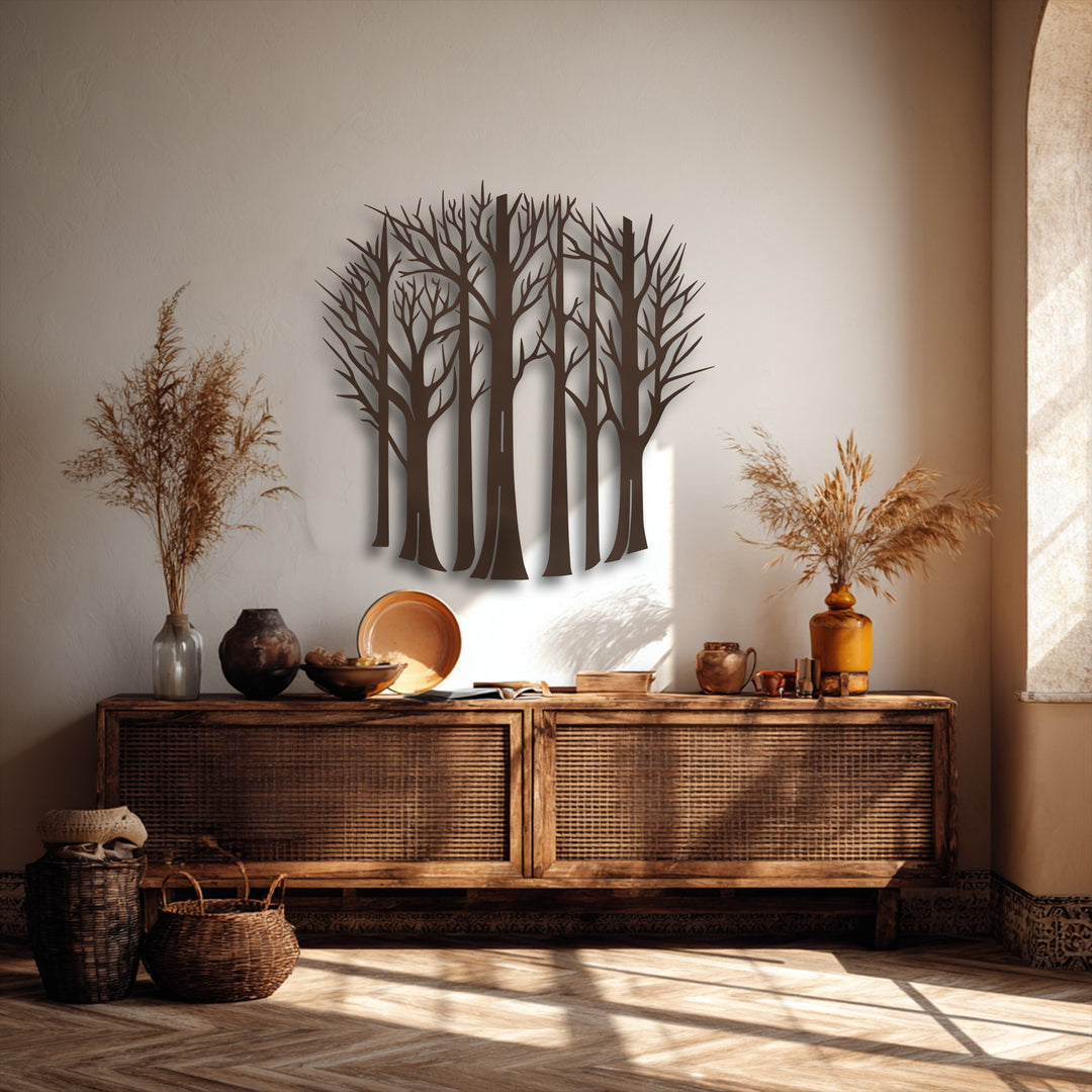 Vertically oriented metal decoration wall art featuring a collection of bare forest trees in an organic silhouette shape.