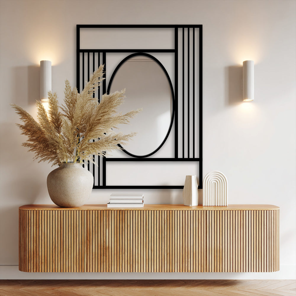 Subtle light and shadow define the modern mirror's oval reflection, framed by a geometric grid of decorative metal art in a naturally lit interior space.