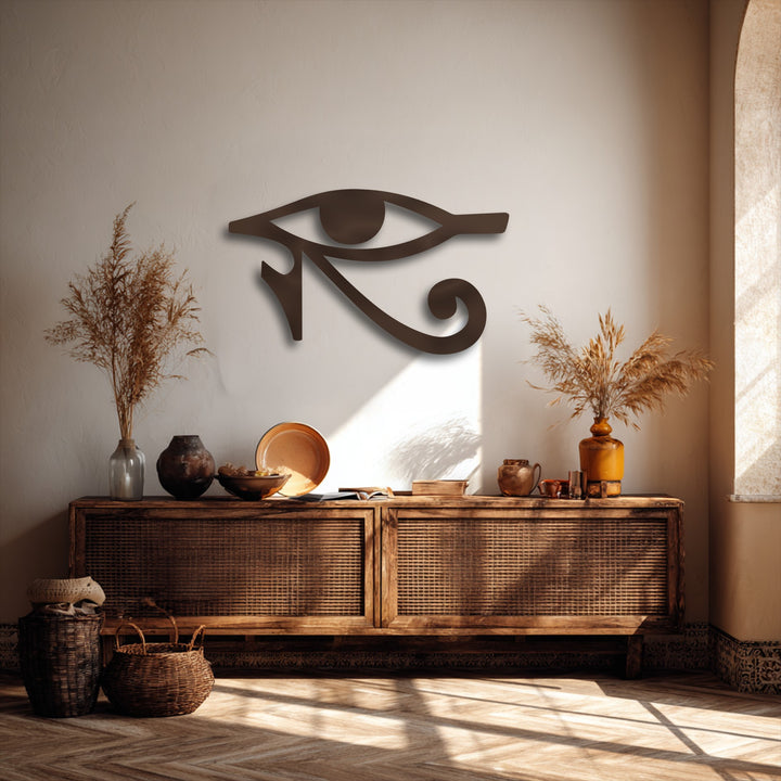 The transition between warm beige wall tones and deep shadows highlights the unique metal wall art featuring the Eye of Horus symbol.