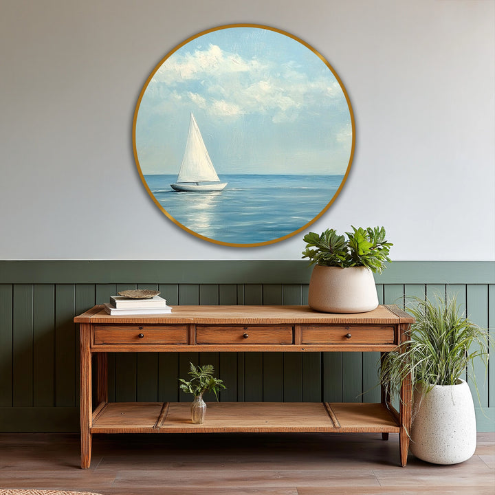 Visual rhythm is created by the painting's repeating soft brushstrokes and the sailboat's simple form in this serene minimalist sailboat round oil painting artwork.