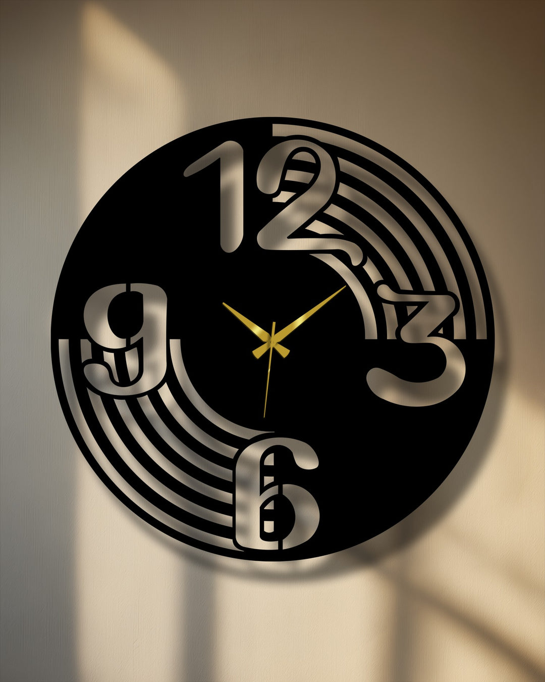 A modern black metal artwork wall clock with large cut-out numbers and a minimal curve design, featuring prominent golden hands.