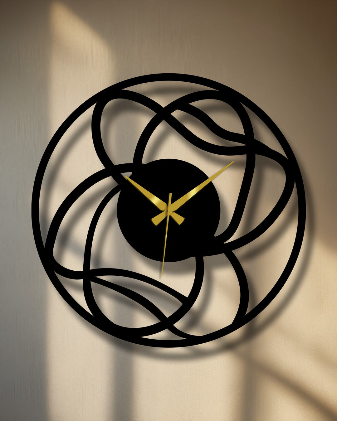 Circular decorative metal art clock features an interwoven abstract design with golden hands, oriented vertically on a neutral surface.
