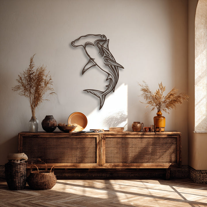 A soft, warm color temperature pervades the scene, featuring a striking unique metal wall art depicting a Hammerhead Shark.