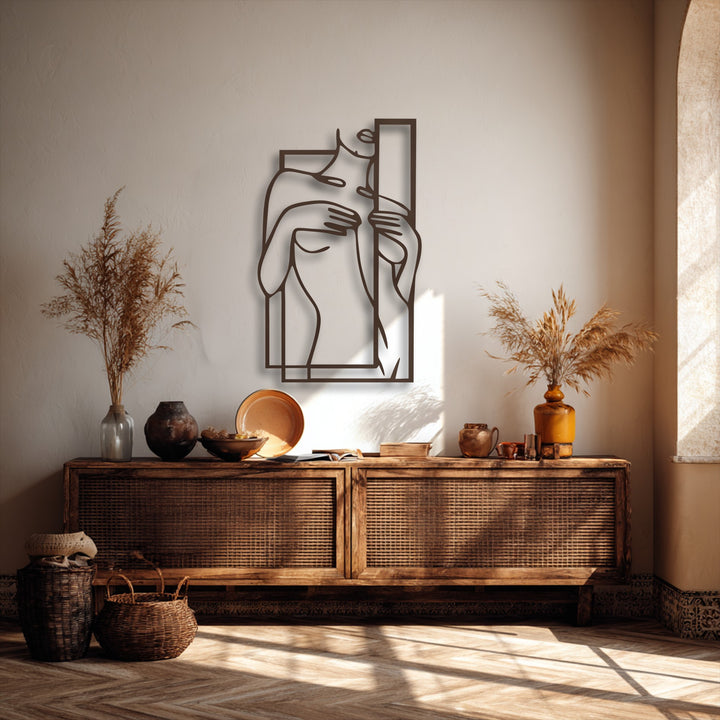 A striking minimalist female figure line art with a geometric frame stands out as elegant metal wall decor, perfectly styled.